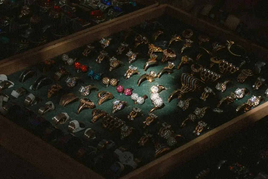 Vintage rings and jewelry arranged in an antique display case